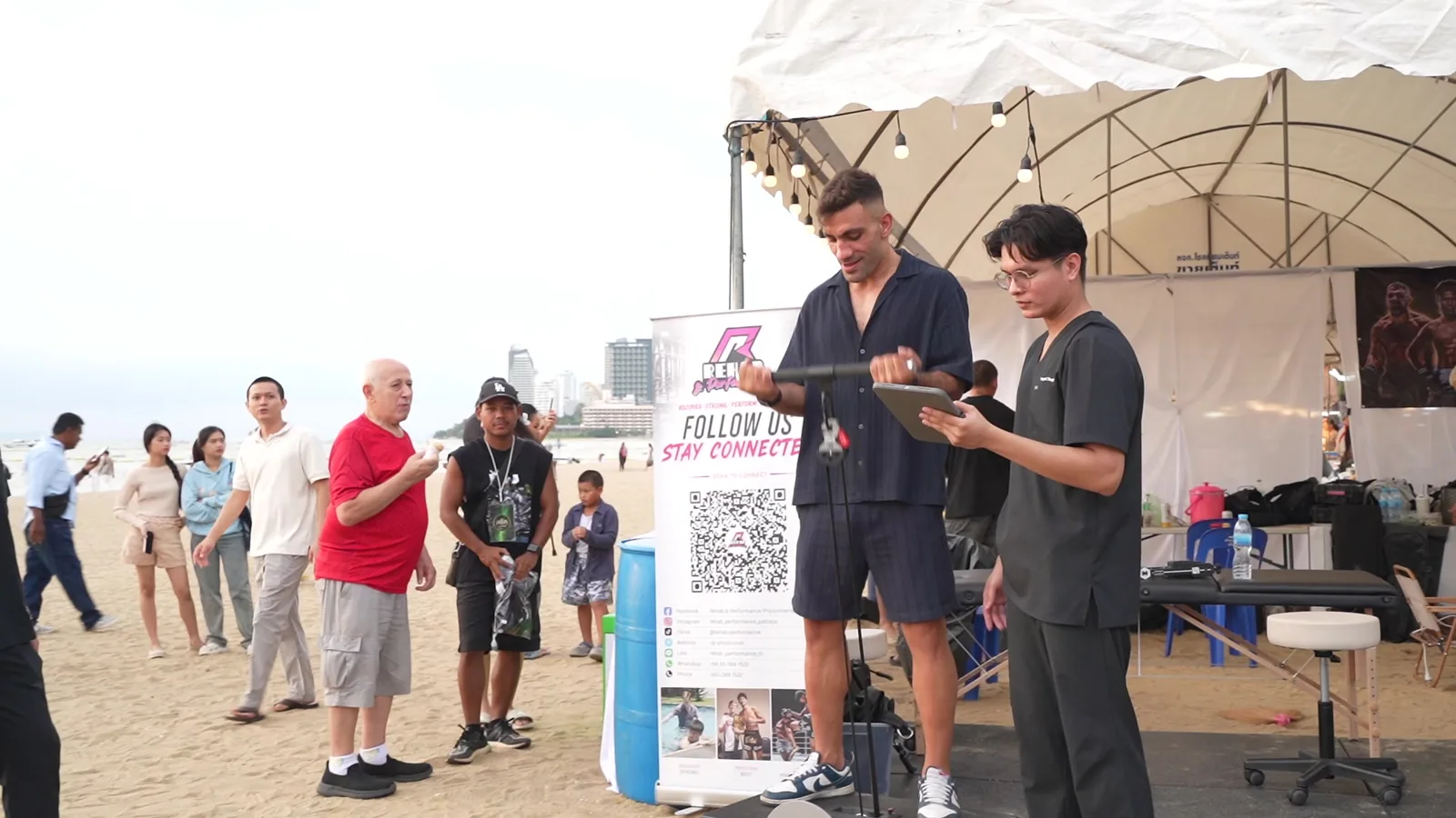 An athlete using flywheel resistance while a coach monitors feedback at the King of Fight event.