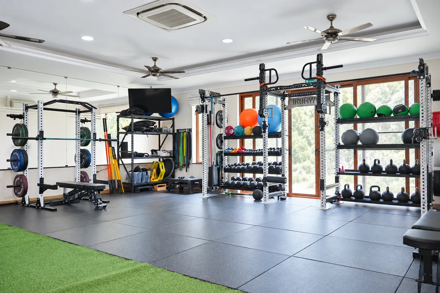 The open R&P training space with exercise floor, strength racks, weights and equipment.