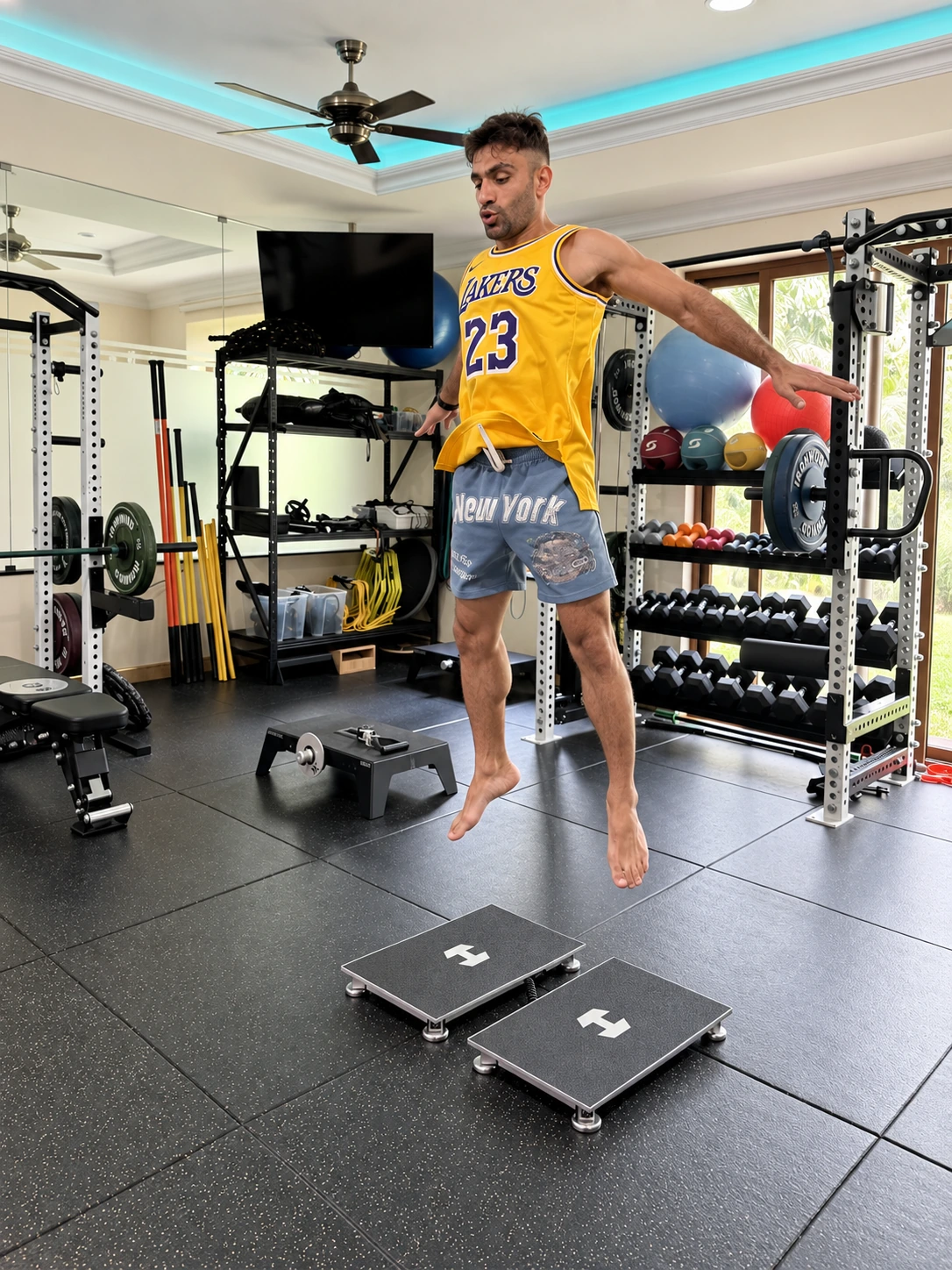 An athlete performing a jump assessment above two Hawkin Dynamics force plates in the R&P gym.