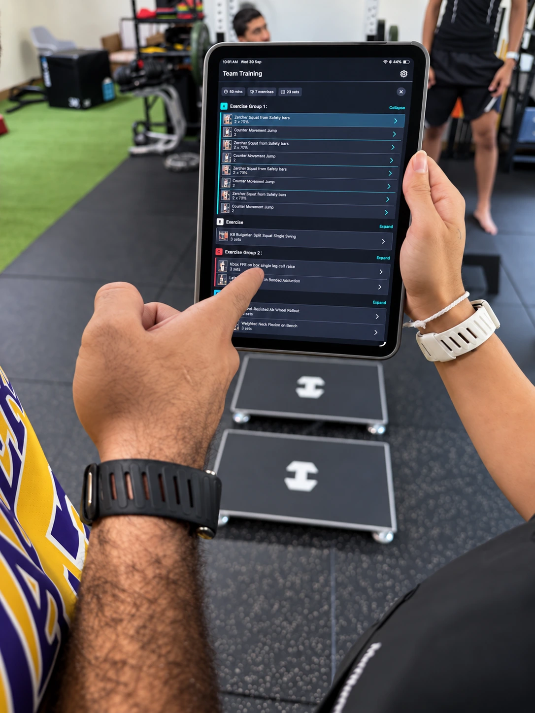 A Lumin Sports training programme on an iPad being reviewed together in the R&P gym.