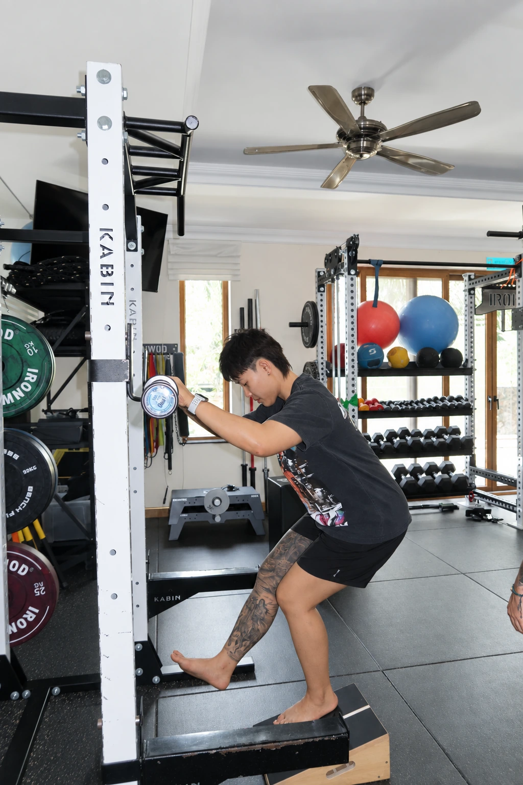 A client practising a supported single-leg exercise.