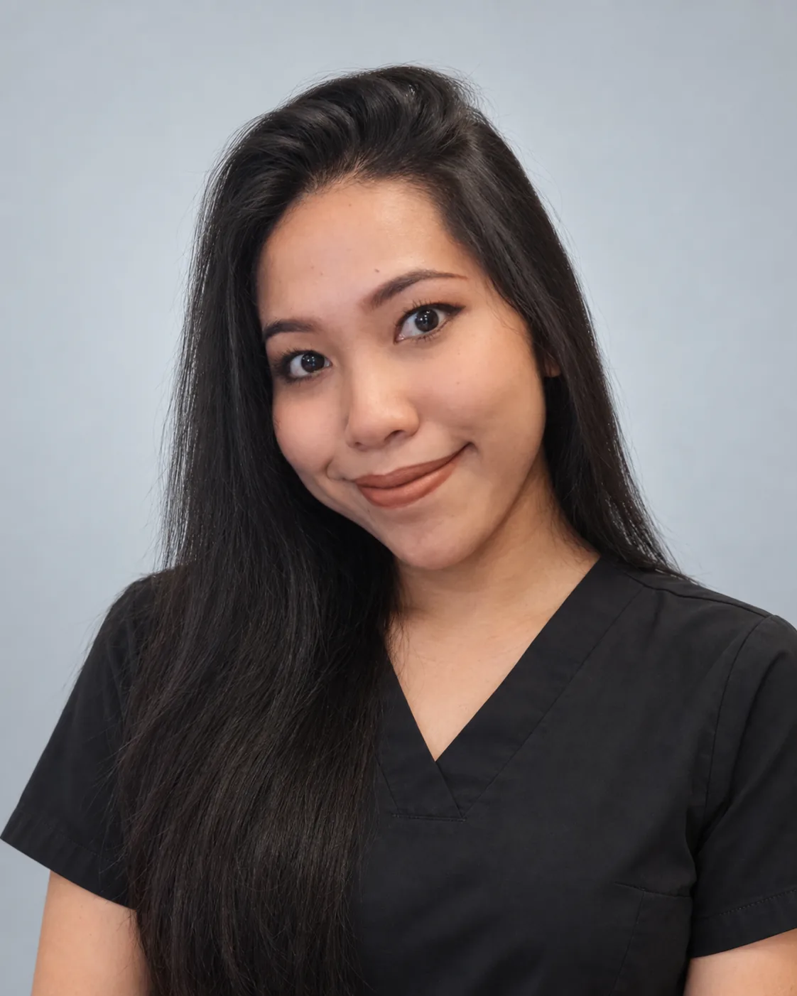 Ratchakarn Peeters wearing black scrubs against a light neutral background.