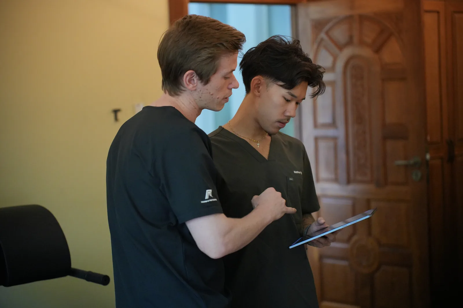Felix and Matthew reviewing information together on a tablet.